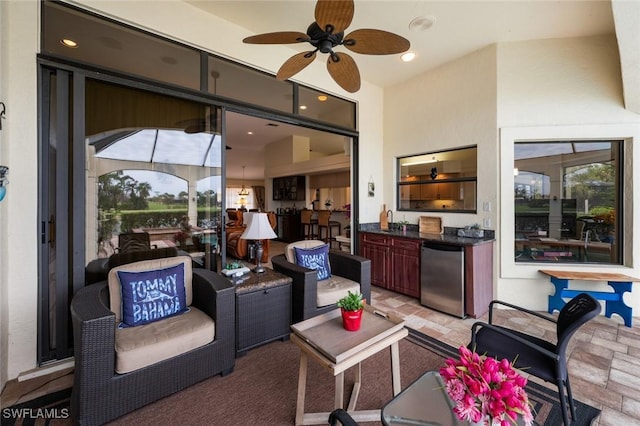 sunroom featuring ceiling fan and sink