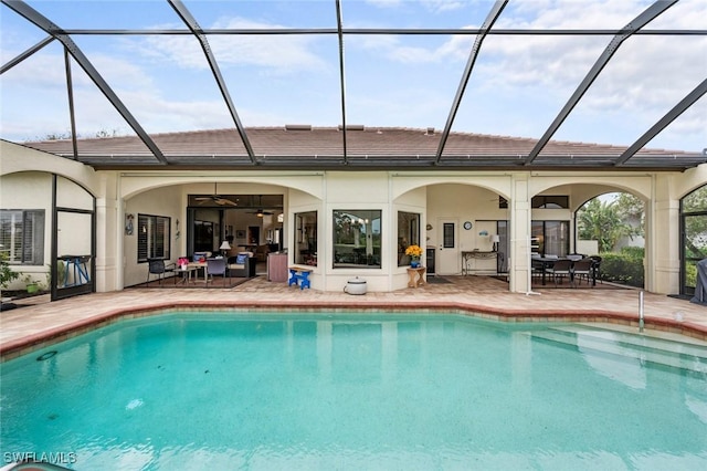 view of pool featuring a lanai, ceiling fan, and a patio