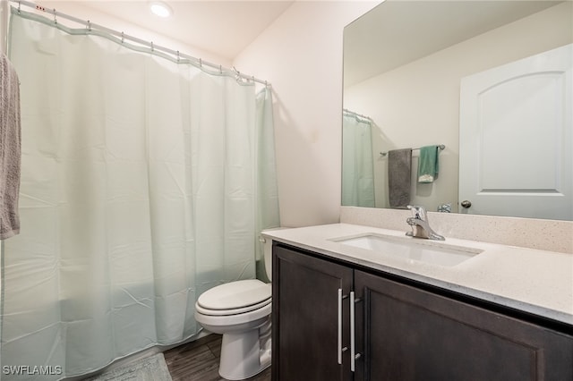 bathroom with hardwood / wood-style floors, vanity, and toilet