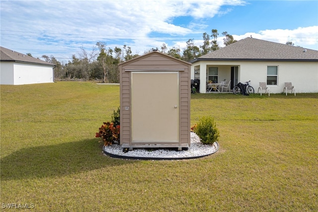 view of outbuilding featuring a lawn