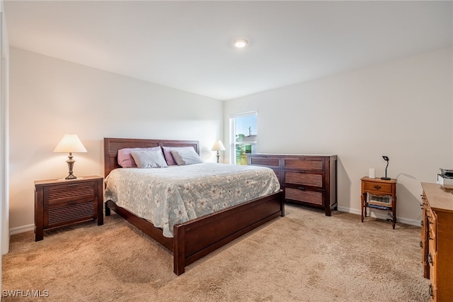 bedroom featuring light colored carpet