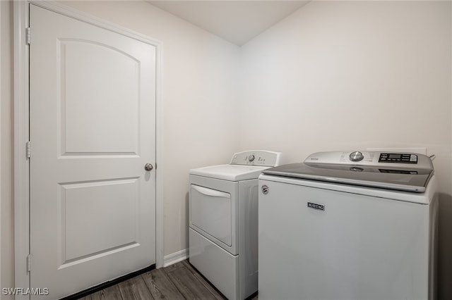 washroom featuring separate washer and dryer and dark hardwood / wood-style floors