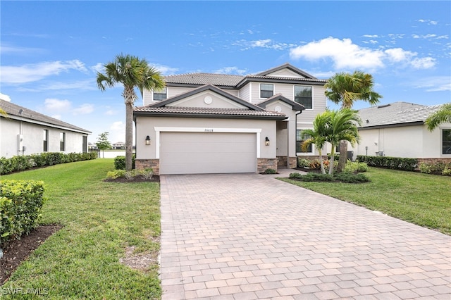 view of front of house with a garage and a front lawn