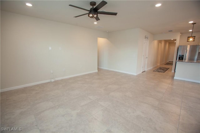 unfurnished living room featuring ceiling fan