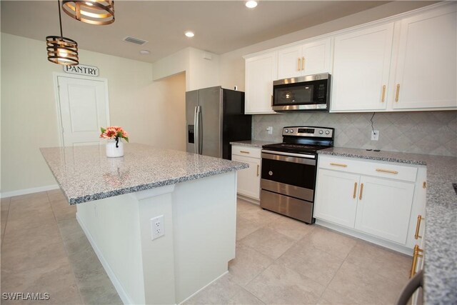 kitchen with backsplash, white cabinetry, light stone counters, and appliances with stainless steel finishes