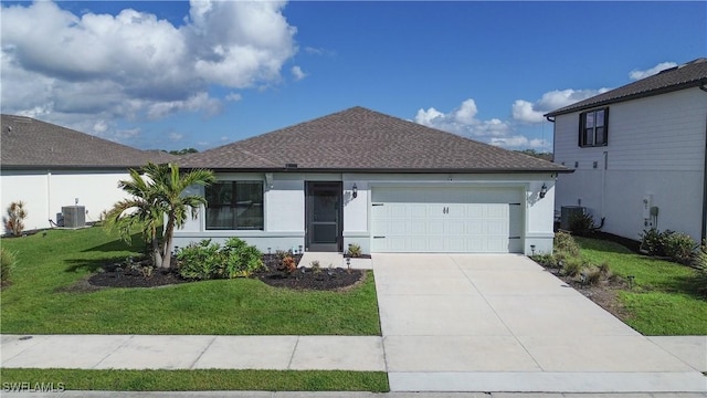 view of front of property with a garage, central AC unit, and a front yard