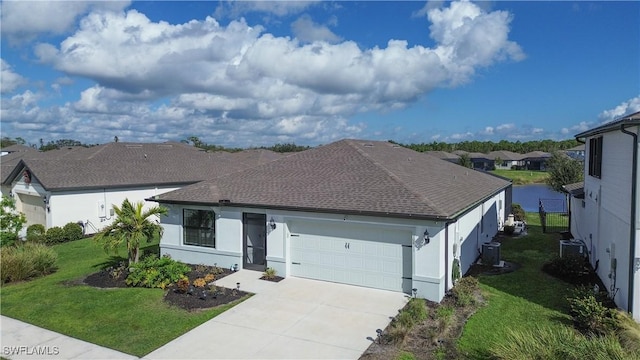 ranch-style house featuring a garage, central air condition unit, and a front yard