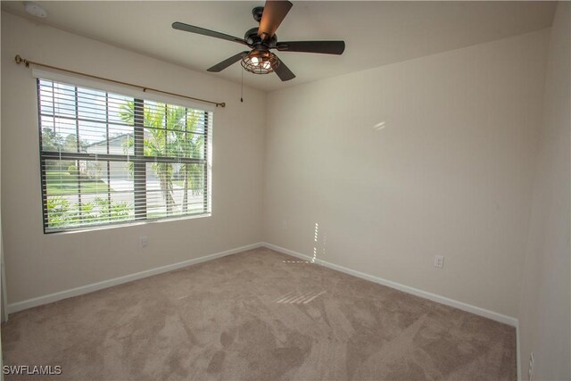 carpeted empty room with ceiling fan