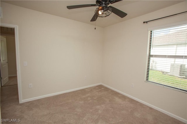 carpeted spare room featuring ceiling fan