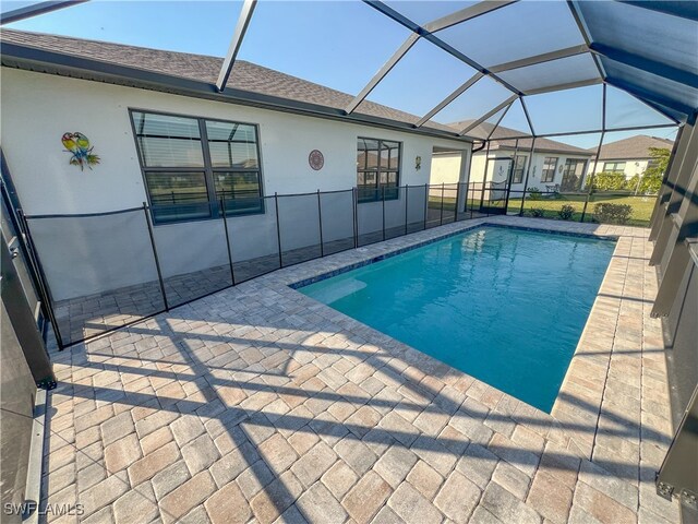 view of pool with a lanai and a patio