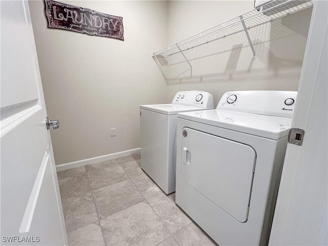 clothes washing area with washing machine and clothes dryer