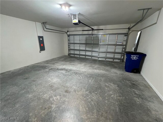 garage featuring electric panel and a garage door opener