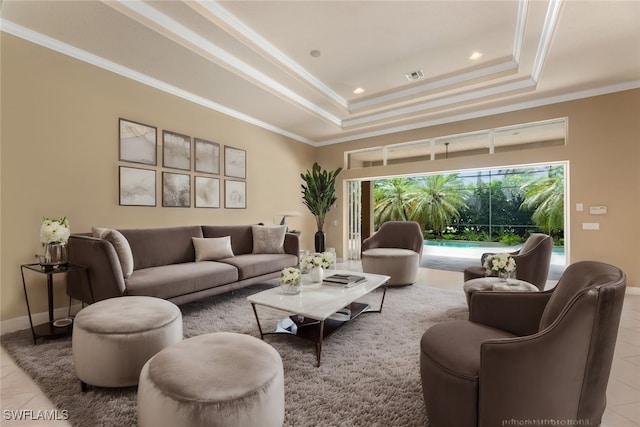 living room with light tile patterned floors, a tray ceiling, and ornamental molding