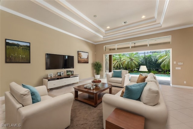 tiled living room featuring a tray ceiling and ornamental molding