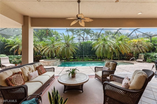 view of patio with ceiling fan, a swimming pool with hot tub, an outdoor living space, and glass enclosure