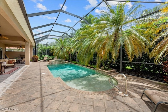 view of swimming pool with glass enclosure, a patio area, an in ground hot tub, and ceiling fan