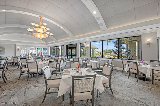 dining room with vaulted ceiling, brick ceiling, and an inviting chandelier