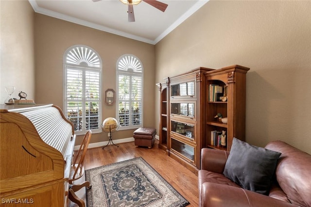 sitting room featuring hardwood / wood-style flooring, ornamental molding, and ceiling fan