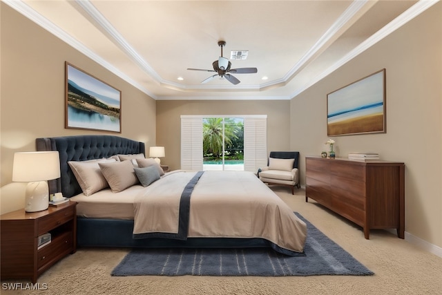 carpeted bedroom featuring ceiling fan, ornamental molding, and a tray ceiling