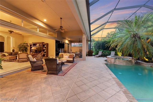 view of swimming pool with glass enclosure, ceiling fan, an outdoor hangout area, an in ground hot tub, and a patio