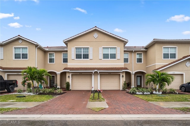 townhome / multi-family property featuring a garage