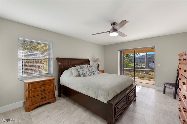 bedroom featuring access to outside, ceiling fan, and multiple windows