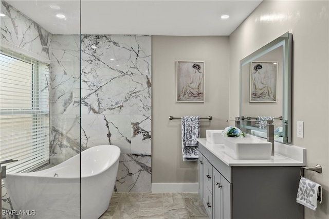 bathroom featuring a tub to relax in and vanity