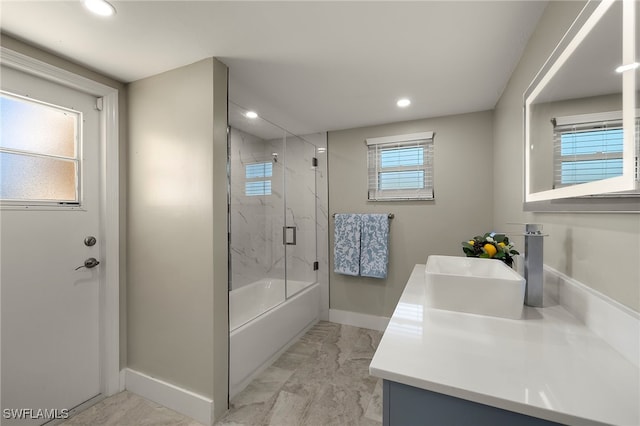 bathroom with combined bath / shower with glass door and vanity