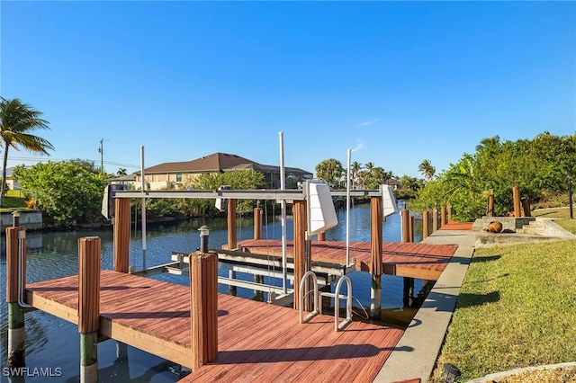 view of dock featuring a lawn and a water view