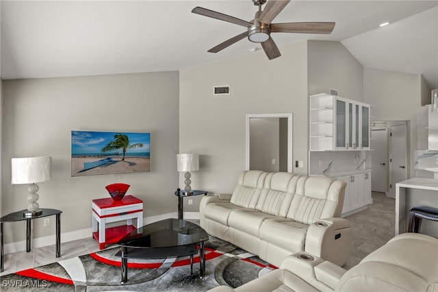 living room featuring ceiling fan and vaulted ceiling