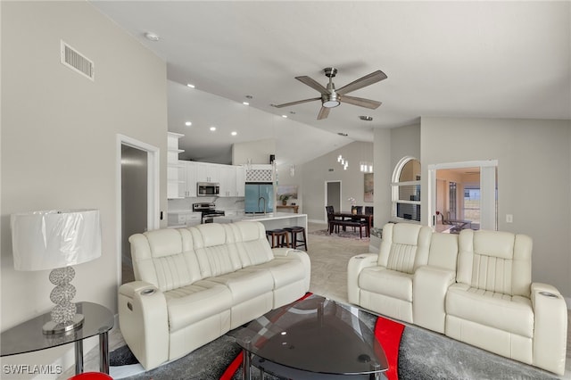 carpeted living room featuring sink, high vaulted ceiling, and ceiling fan