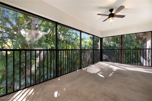 unfurnished sunroom featuring ceiling fan