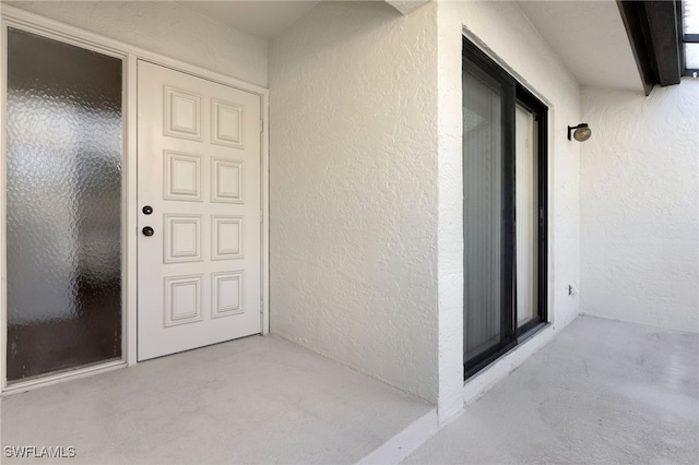 doorway to property with a patio