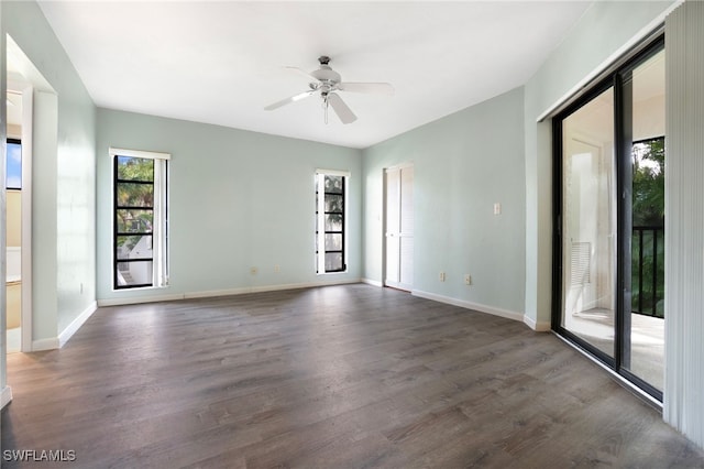 empty room featuring ceiling fan and dark wood-type flooring