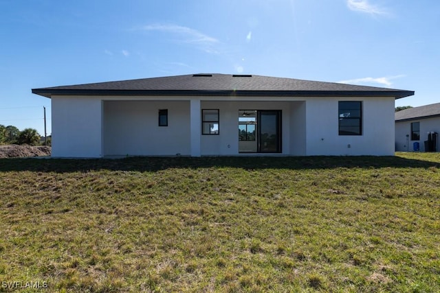 rear view of property with a lawn