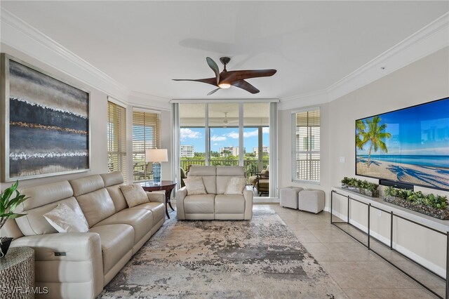 living room with crown molding, ceiling fan, and light tile patterned floors