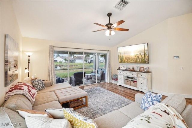 living room featuring vaulted ceiling, hardwood / wood-style floors, and ceiling fan