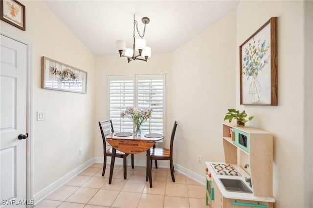 dining area with an inviting chandelier, vaulted ceiling, and light tile patterned floors