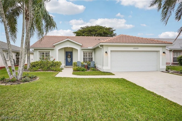 view of front of home with a garage and a front yard