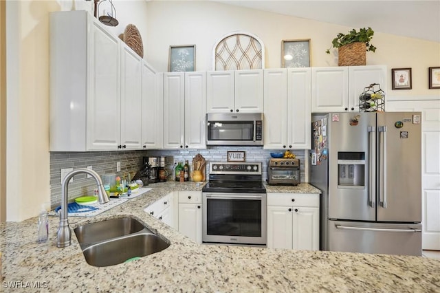 kitchen featuring appliances with stainless steel finishes, sink, and white cabinets