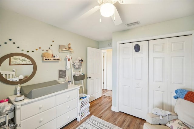 bedroom featuring light hardwood / wood-style floors, a closet, and ceiling fan