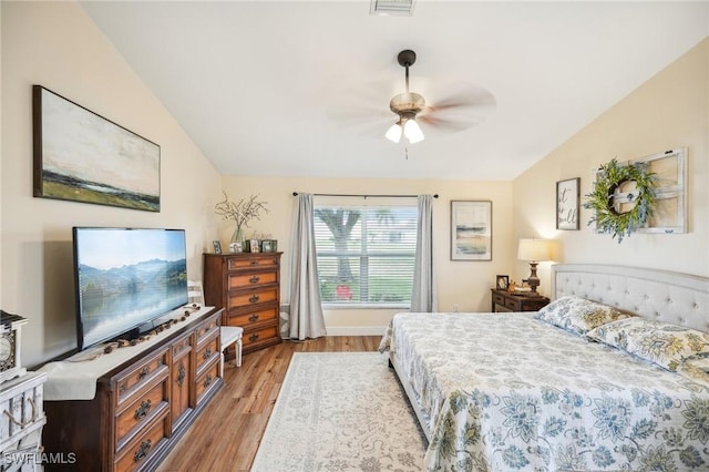 bedroom featuring ceiling fan, lofted ceiling, and light hardwood / wood-style floors