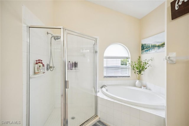 bathroom featuring shower with separate bathtub