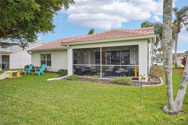 back of property featuring a yard and a sunroom