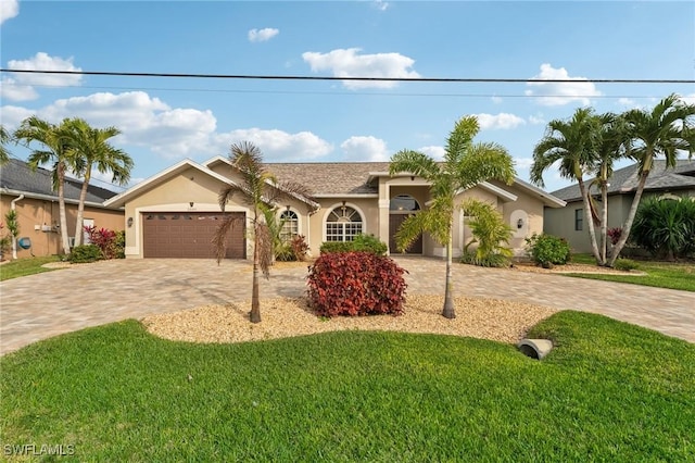 ranch-style house with a garage and a front yard