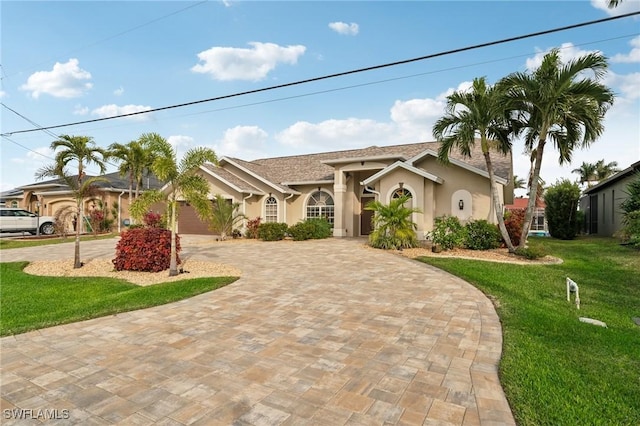 view of front of home featuring a garage and a front yard