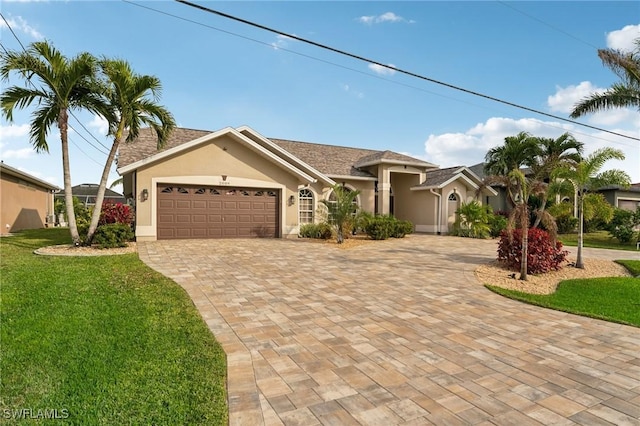 view of front of property with a garage and a front yard