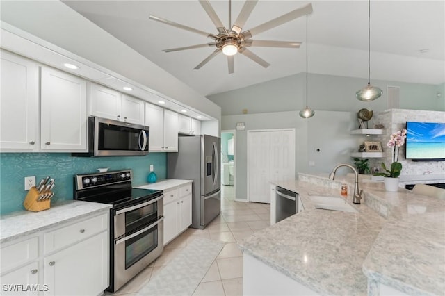 kitchen featuring appliances with stainless steel finishes, pendant lighting, sink, white cabinets, and backsplash