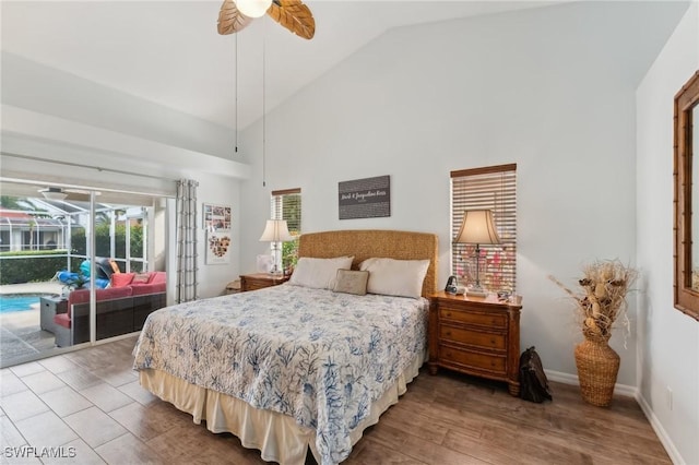 bedroom with hardwood / wood-style flooring, access to outside, high vaulted ceiling, and ceiling fan