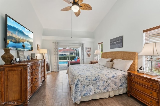 bedroom featuring dark hardwood / wood-style floors, ceiling fan, access to exterior, and high vaulted ceiling